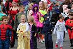  Young students walking in Halloween costumes. 