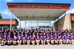 Large group of students wearing purple.