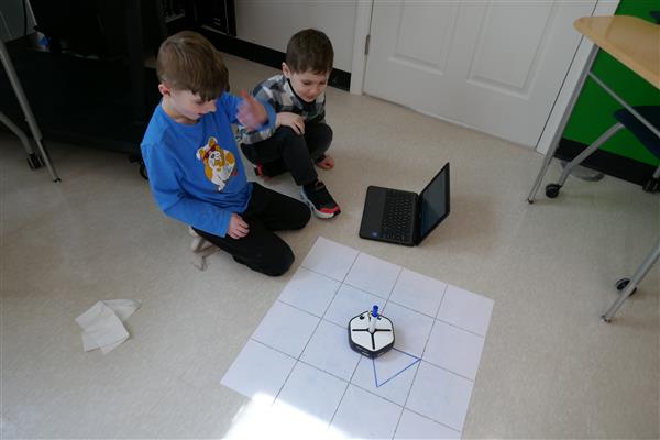 2 students working with robot 