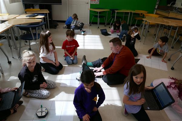 Class and teacher using robots