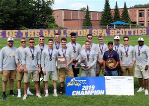 A team of male students posing with medals and placards for winning a 2019 championship.